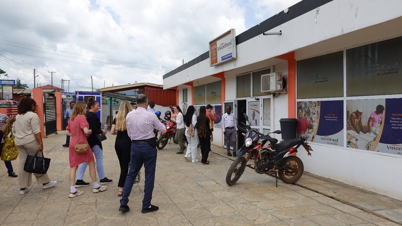 field trip participants in front of Vision Fund