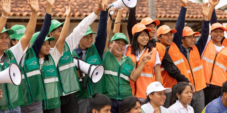 School emergency brigade A big group of students in the school emergency brigade uniform wave to the camera